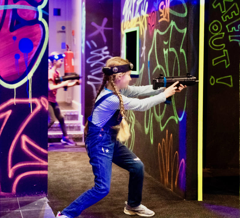 Girl aiming in the laser tag arena